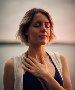 person with hand over their heart