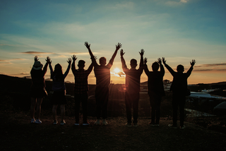 Group of people with their hands in the air