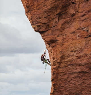 person climbing cliff