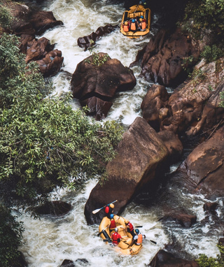 birds-eye view of people white-water rafting