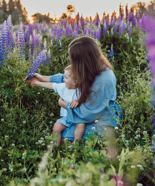 woman and baby touching lavender